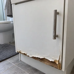 A worn vanity cabinet door